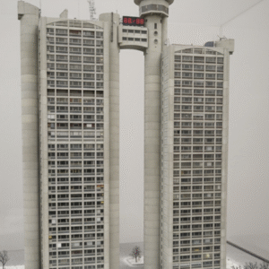 Miniature model kit of the Genex Tower in Belgrade, featuring detailed Brutalist architecture with twin towers and connecting bridge.